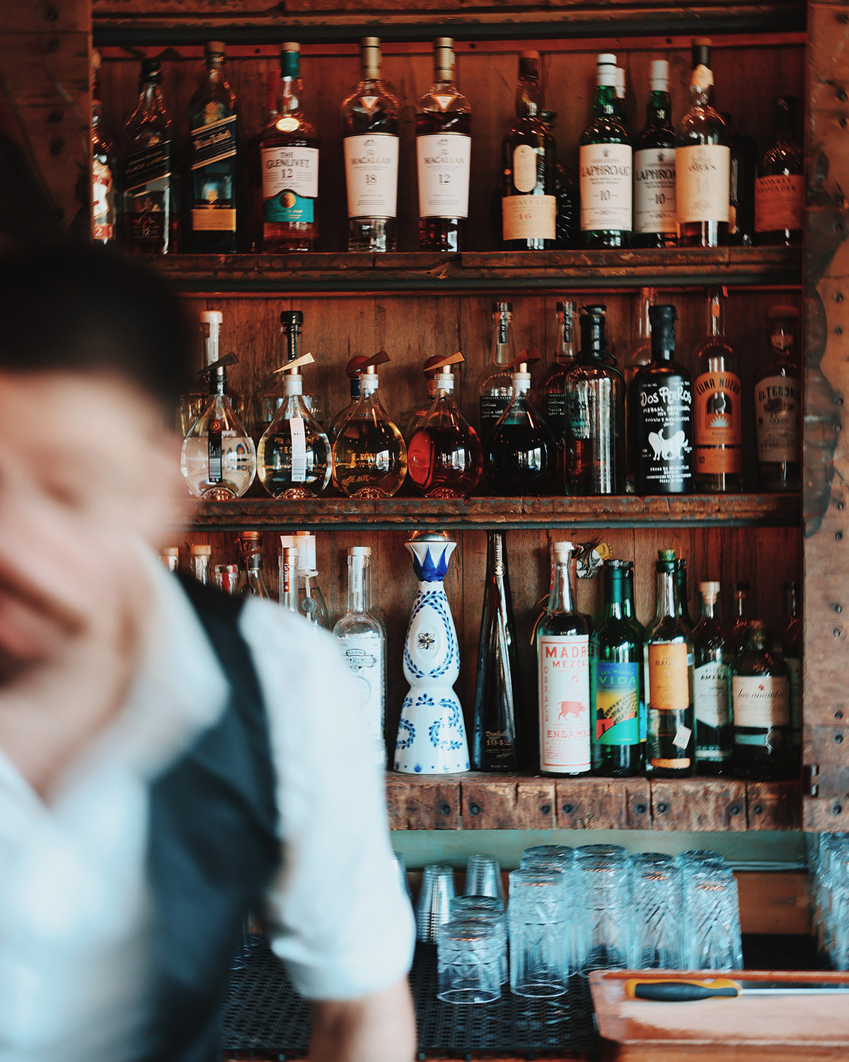 Bar shelves stocked with spirits and bottles