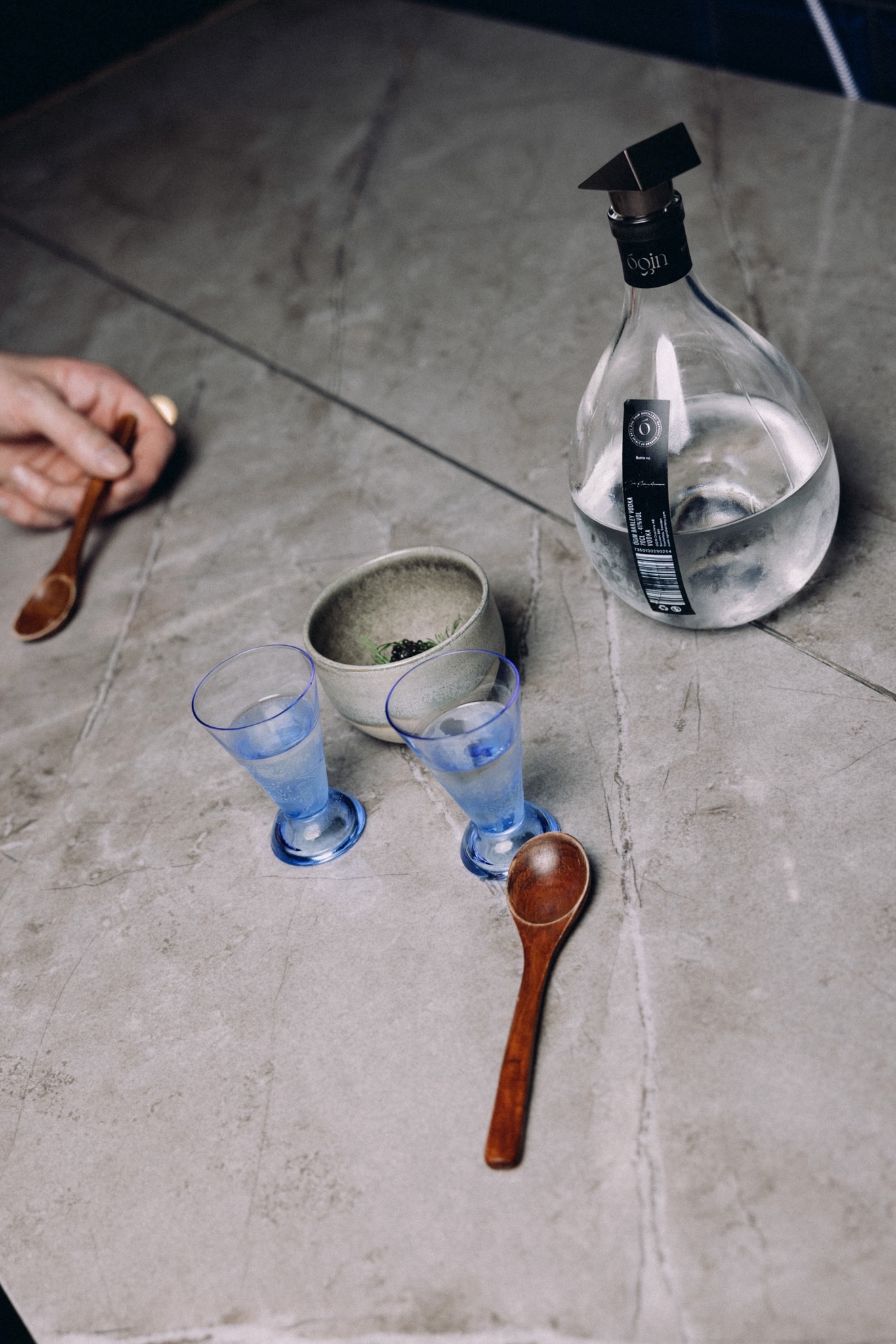 ÓGIN vodka bottle with caviar and blue glasses