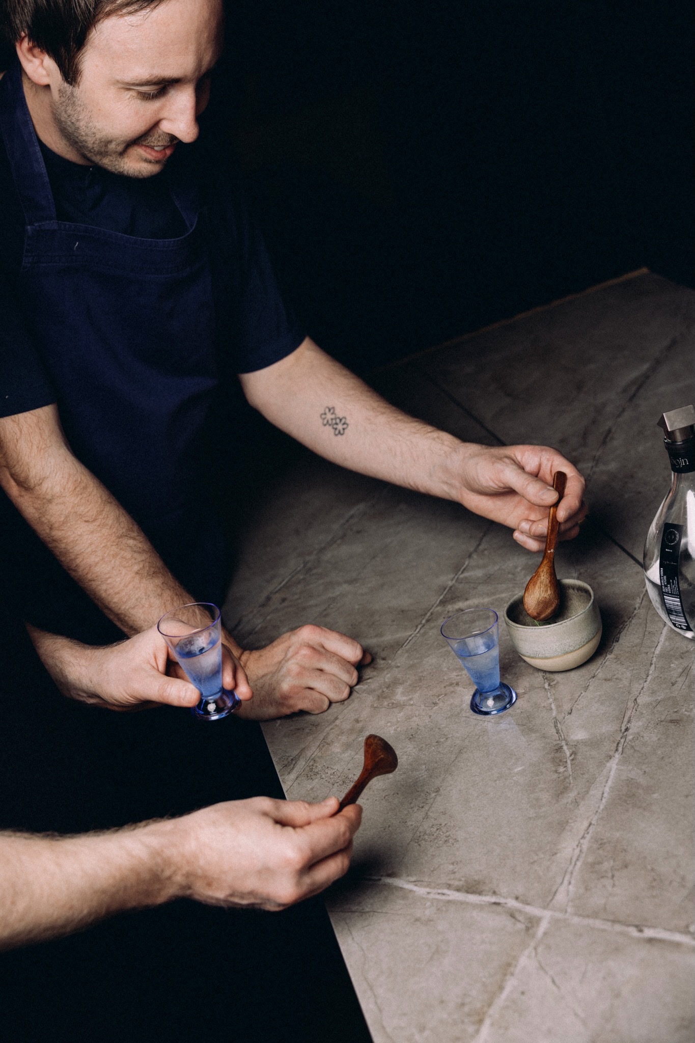 Vodka tasting with blue glasses and wooden spoons